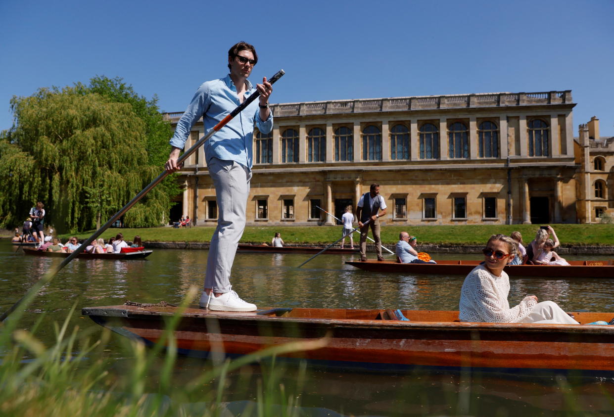 Boat ride by the Trinity College on the River Cam in Cambridge, UK business