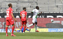 Moenchengladbach's Marcus Thuram, right, scores his side's third goal during the German Bundesliga soccer match between Borussia Moenchengladbach and Union Berlin in Moenchengladbach, Germany, Sunday, May 31, 2020. The German Bundesliga becomes the world's first major soccer league to resume after a two-month suspension because of the coronavirus pandemic. (AP Photo/Martin Meissner, Pool)