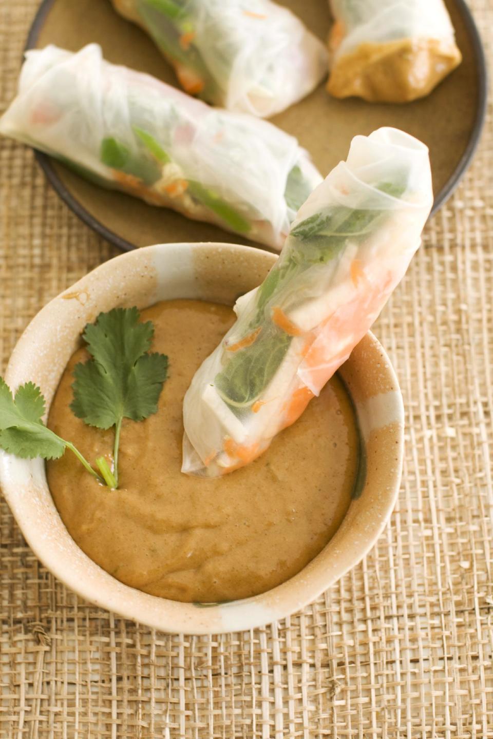 In this image taken on May 13, 2013, summer rolls with spicy peanut dipping sauce are shown served on a plate in Concord, NH. (AP Photo/Matthew Mead)
