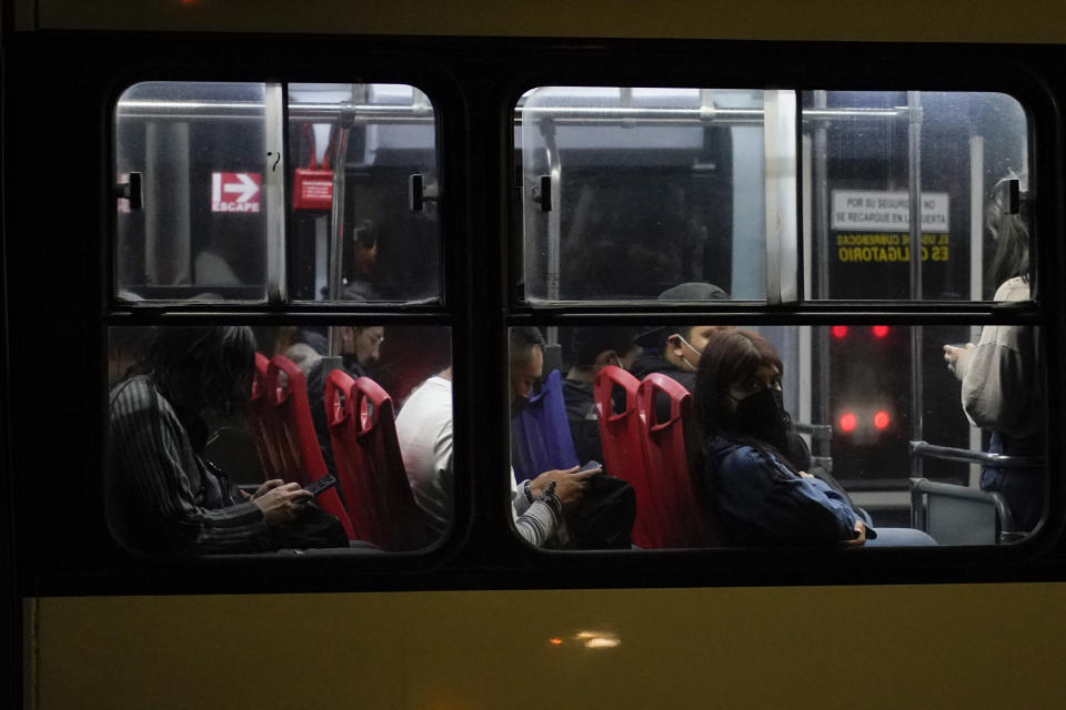 A woman peers from a bus window late at night in Ecatepec, State of Mexico, Mexico, Sunday, July 22, 2022. The State of Mexico ranks 10th among the country’s 32 states in femicides per 100,000 women. Dilcya García, who leads the Mexico state prosecutor’s office on gender violence, said the issue is part of the cement of Mexico’s social structure. (AP Photo/Eduardo Verdugo)