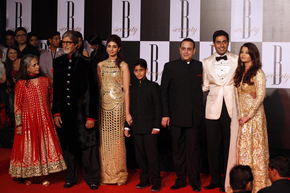 Bollywood star Amitabh Bachchan, second left, poses for photographers along with family members, wife Jaya Bachchan, left, daughter Shweta Nanda, third left, son-in-law Nikhil Nanda, third right, son Abhishek Bachchan, second right, and daughter-in-law Aishwarya Rai-Bachchan during a party on the eve of his 70th birthday in Mumbai, India, Wednesday, Oct. 10, 2012. Affectionately known as "Big B," Bachchan has acted in around 180 films in a career spanning four decades in Bollywood, the home of India's prolific movie industry. (AP Photo/ Rajanish Kakade)