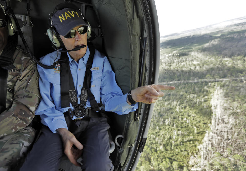 Florida Gov. Rick Scott points out some damage caused by Hurricane Michael while flying somewhere over the panhandle of Florida Thursday, Oct. 11, 2018. The devastation inflicted by Hurricane Michael came into focus Thursday with rows upon rows of homes found smashed to pieces, and rescue crews began making their way into the stricken areas in hopes of accounting for hundreds of people who may have stayed behind. (AP Photo/Chris O'Meara)