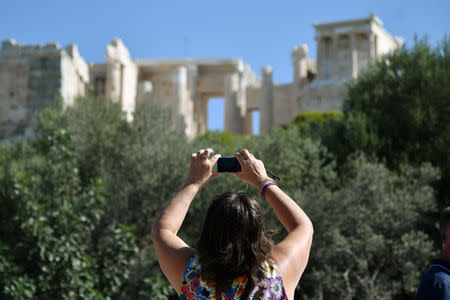 A tourist takes pictures of the Acropolis in Athens, Greece, October 11, 2018. REUTERS/Michalis Karagiannis