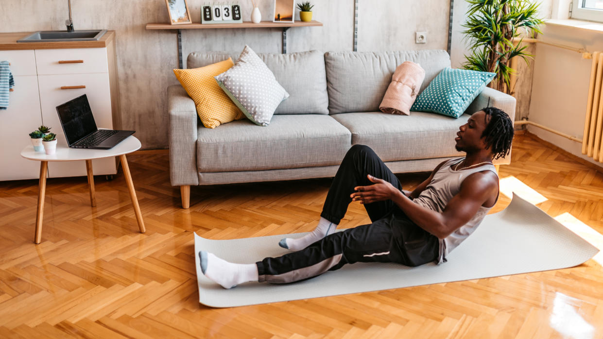  Man practicing yoga at home 