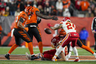 Kansas City Chiefs tight end Travis Kelce (87) fumbles the ball under Cincinnati Bengals linebacker Germaine Pratt, left center, and linebacker Logan Wilson, left, in the second half of an NFL football game in Cincinnati, Fla., Sunday, Dec. 4, 2022. (AP Photo/Jeff Dean)