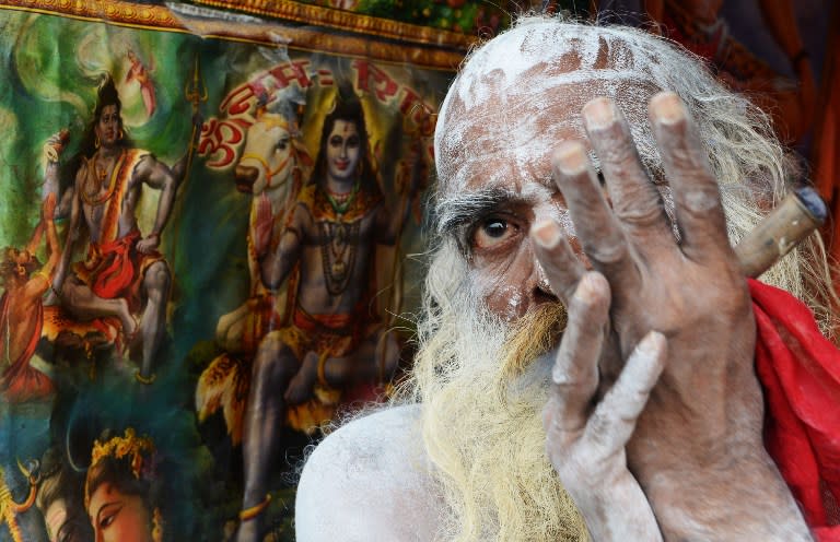 <p>An Indian sadhu smokes cannabis at his temporary camp on Gangasagar Island, around 150 km south of Kolkata, on January 13, 2016. More than 500,000 Hindu pilgrims and sadhus are expected to gather at the confluence of the River Ganges and the Bay of Bengal during the Gangasagar Mela to take a ‘holy dip’ in the ocean on the occasion of Makar Sankranti, a holy day of the Hindu calendar considered to be of great religious significance in Hindu mythology. </p>