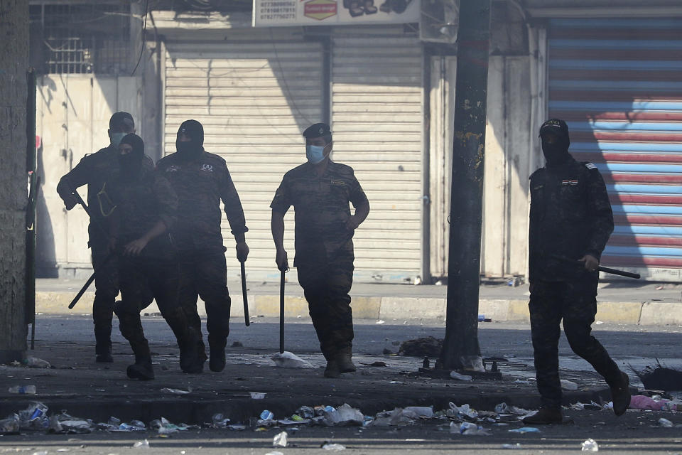Iraqi security forces try to disperse anti-government protesters during ongoing protests in central Baghdad, Iraq, Saturday, Nov. 9, 2019. (AP Photo/Hadi Mizban)