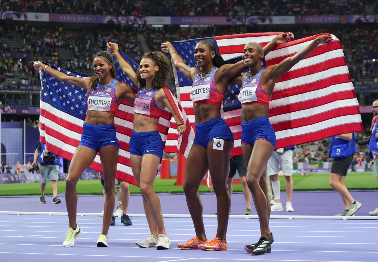 USA runners celebrate after winning gold in the women's 4x400.