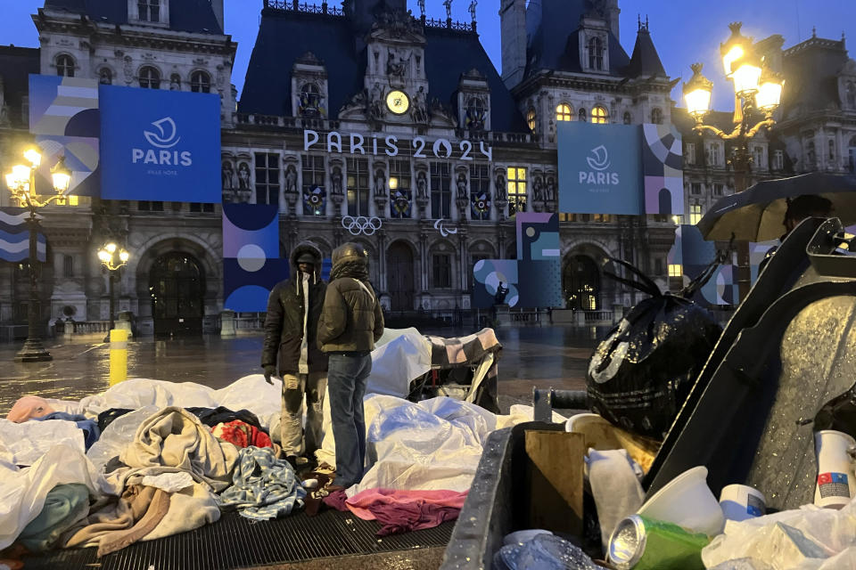 FILE - Migrants stand in front of the Paris City Hall, Wednesday, April 3, 2024. Earlier this month, French police removed about 50 migrants, including families with young children, from the forecourt of Paris City Hall. The migrants packed belongings and boarded a bus to temporary government housing in the town of Besançon in eastern France. (AP Photo/Nicolas Garriga , File)