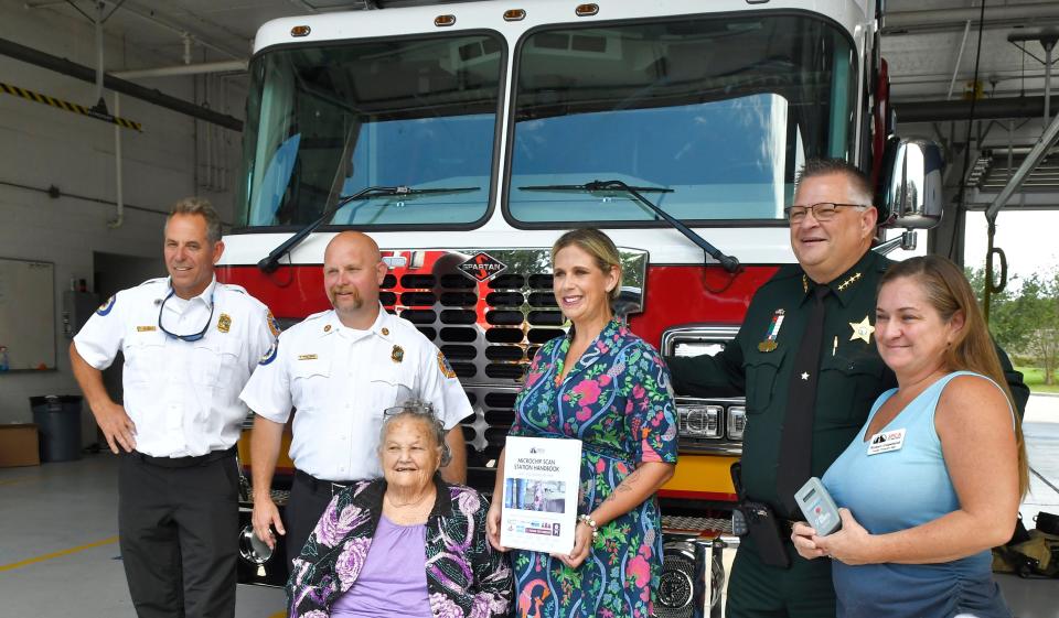 Left to right, BCFR Chief Tom Neidert, BCFR Chief Patrick Voltaire, Edna Corney, president of Brevard Kennel Club, Susan Naylor of SPCA of Brevard, Sheriff Wayne Ivey, and Robyn Copeland of the SPCA of Brevard at Brevard County Fire Rescue Station 48 in Viera, which was presented with 22 pet microchip scanners to be distributed to their stations, thanks to a community program by the SPCA of Brevard, and a sponsorship by the Brevard Kennel Club. The scanners, which will help crews when finding stray animals, and for the public who find animals to bring them to any of the 32 BCFR stations to be scanned, cost about $200 each, and were paid for by a number of sponsors to get 32 so far. The SPCA has a program to provide scanners for many of the city and county fire and police stations.