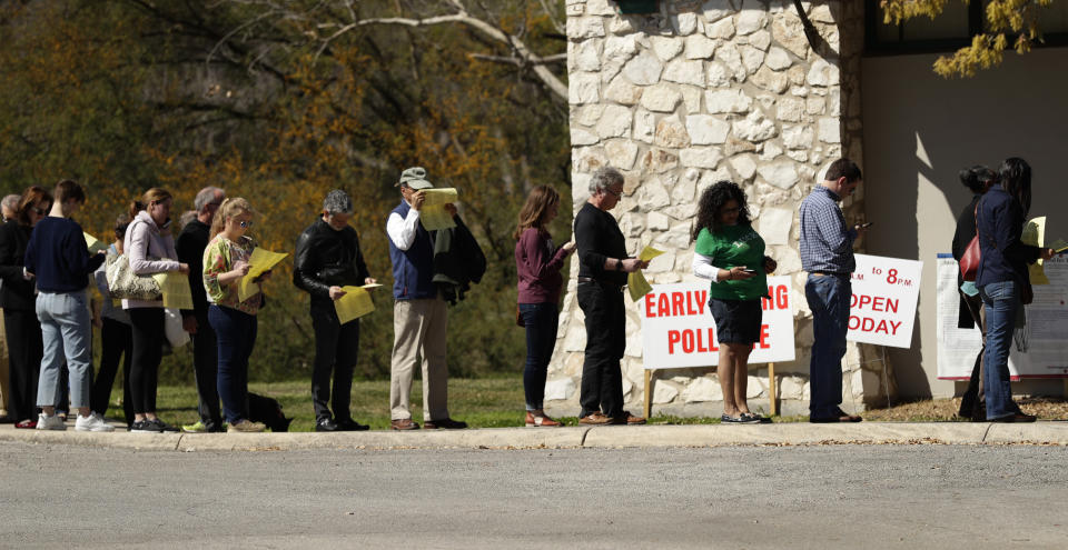 In this Friday, Feb. 28, 2020 photo, voters wait in line at an early polling site in San Antonio. California and Texas are the most populous states in the nation and the biggest delegate prizes for the candidates, yet they also present a stark contrast in voting laws. (AP Photo/Eric Gay)