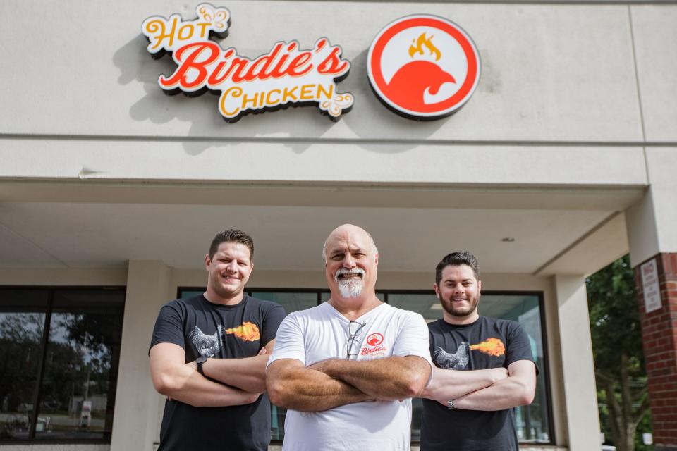 Kevin Stout, owner of Food Glorious Food and Hot Birdie's Chicken, center, poses in front of his new restaurant with his directors of operations Eric and Matt Rodin Wednesday, Sept. 15, 2021.