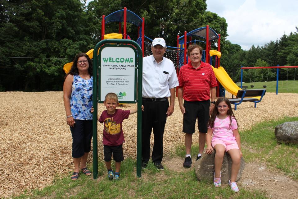 Pictured are Geoffrey and Carla Liban and grandkids along with Manitowoc County Executive Bob Ziegelbauer at the Lower Cato Falls Park Playground.