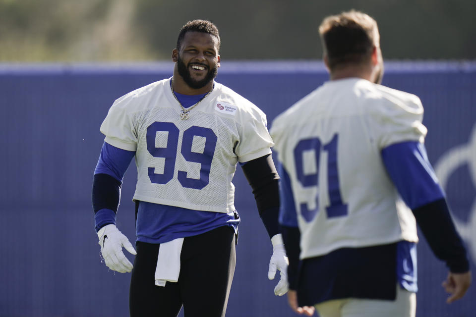 Los Angeles Rams defensive tackle Aaron Donald, left, shares a light moment with defensive tackle Greg Gaines during an NFL football camp practice Thursday, Aug. 27, 2020, in Thousand Oaks, Calif. (AP Photo/Jae C. Hong)