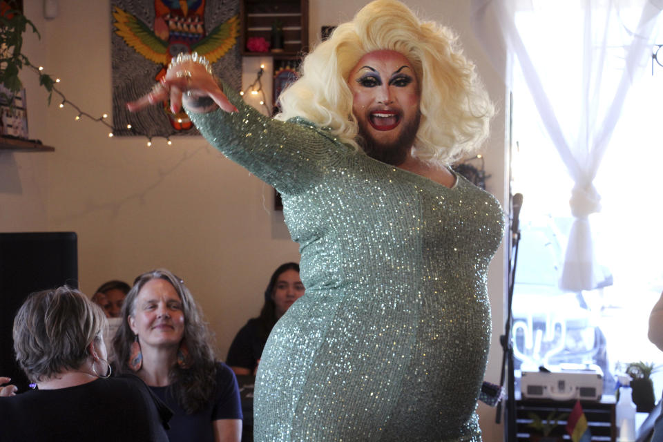 This July 28, 2022, photo shows emcee Golden Delicious performing before a mock election at Cafecito Bonito in Anchorage, Alaska, where people ranked the performances by drag performers. Several organizations are using different methods to teach Alaskans about ranked choice voting, which will be used in the upcoming special U.S. House election. (AP Photo/Mark Thiessen)