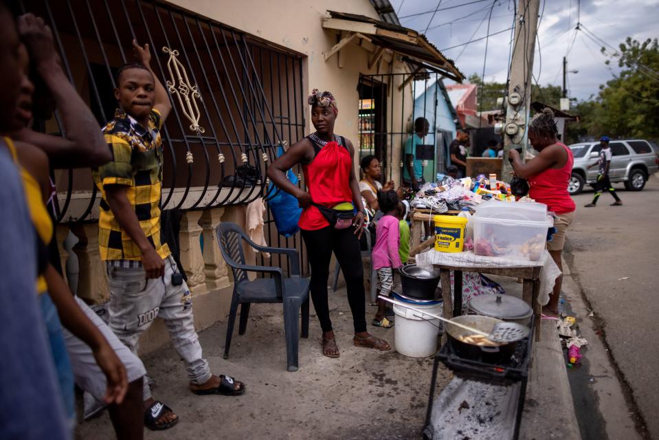 To make a living, Sandra Jean-Mary operates a food stand in Batey Libertad, selling fried foods she learned to make as a youth in Haiti. | Spenser Heaps, Deseret News