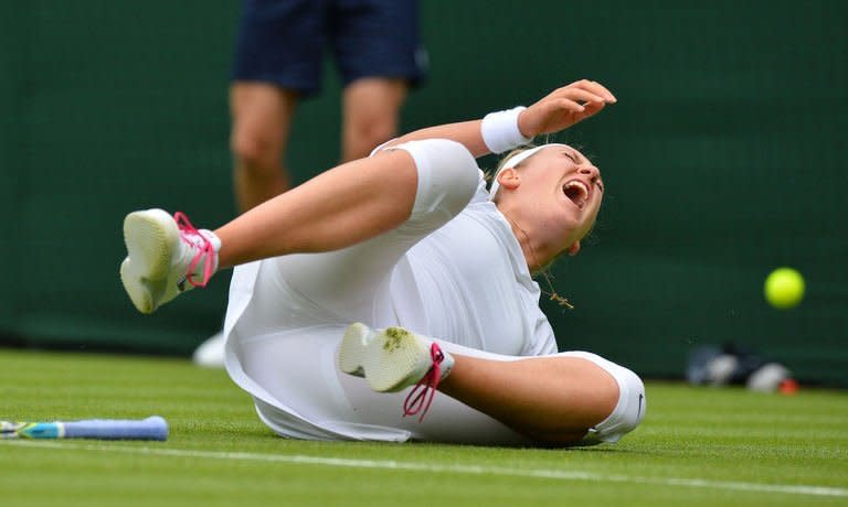 In a picture taken on June 24, 2013 Belarus's Victoria Azarenka falls on court. Azarenka withdrew injured from Wimbledon on June 26, 2013