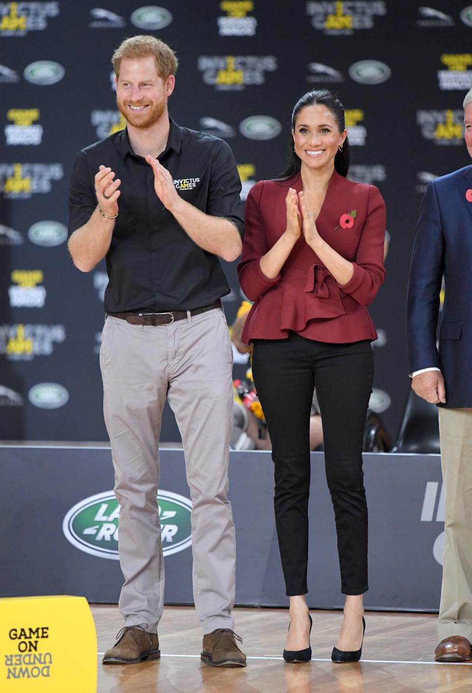 Markle cheered on the finalists of the Invictus Games' basketball tournament in a casual-chic outfit: a Scanlan Theodore wrap jacket, black Outland jeans, and Sarah Flint heels.