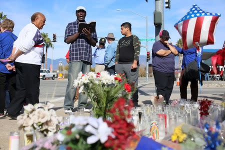 Mourners gather around a makeshift memorial in honor of victims following Wednesday's attack in San Bernardino, California December 5, 2015. REUTERS/Sandy Huffaker