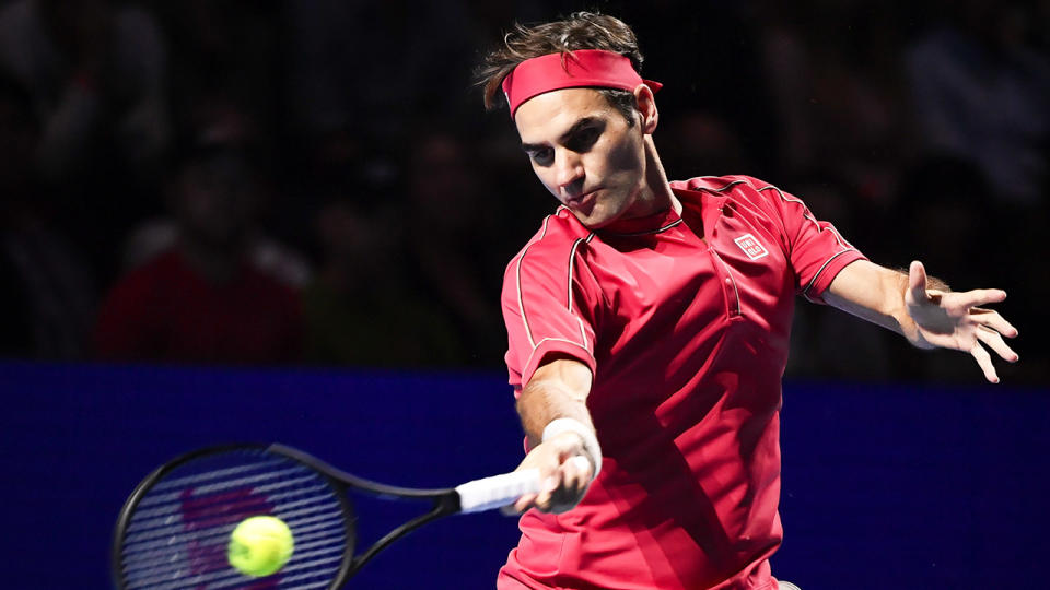 Roger Federer hitting ball during his 1,500th victory in Basel.