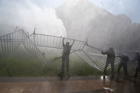 A jet of water is released on demonstrators during a protest calling for changes in the education system in Santiago, Chile April 11, 2017. REUTERS/Ivan Alvarado