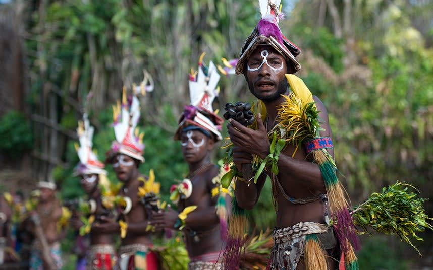 Tribal warriors perform a traditional welcome, - RENATO GRANIERI