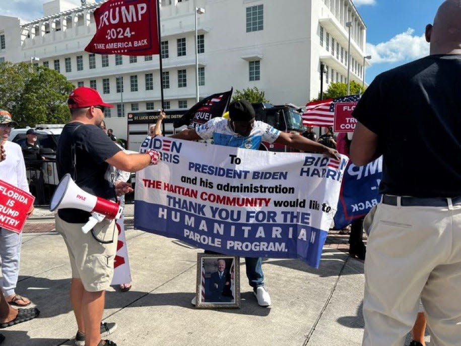 Jean Corioland, 44, immigrated to the United States from Haiti about a year ago. He's showing support for President Joe Biden.