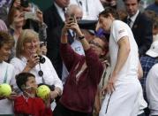 Britain Tennis - Wimbledon - All England Lawn Tennis & Croquet Club, Wimbledon, England - 30/6/16 Great Britain's Andy Murray poses for a selfie with a fan as he celebrates winning his match against Chinese Taipei's Yen-Hsun Lu REUTERS/Andrew Couldridge