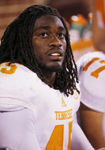 FILE - In this Sept. 13, 2014, file photo,Tennessee linebacker A.J. Johnson sits on the bench during an NCAA college football game between Tennessee and Oklahoma in Norman, Okla. Tennessee has suspended leading tackler Johnson and defensive back Michael Williams amid a sexual assault investigation. The school announced Monday, Nov. 17 on the football program&#39;s Twitter account that both players had been suspended &quot;from all team-related activities&quot; without going into further details. (AP Photo/Sue Ogrocki, File)