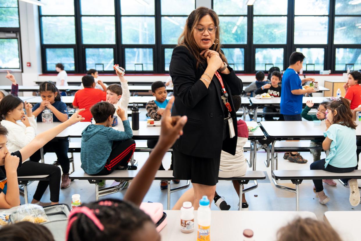 Jasibi Crews, principal of Cora Kelly School for Math, Science and Technology in Alexandria, Va., greets students during lunch.