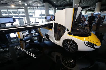 People look at the AeroMobil flying car during its unveiling at the Top Marques Monaco supercar show in Monaco April 20, 2017. REUTERS/Jean-Paul Pelissier