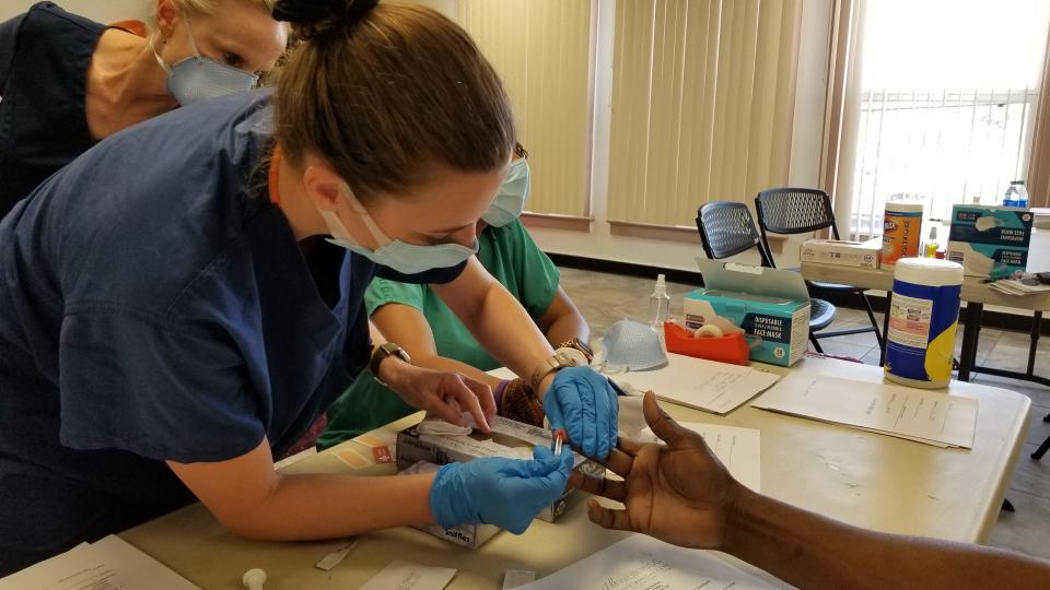 Nurse practitioner Dina Balzano takes a blood sample from Donnell Knight during a COVID-19 antibodies testing event at the Chandler Salvation Army on May 8.