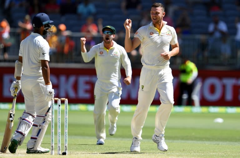 Australia's paceman Josh Hazlewood (R) celebrates after dismissing India's Cheteshwar Pujara (L) during day four of the second Test cricket match between Australia and India in Perth on December 17, 2018