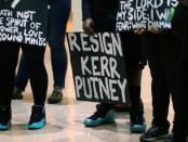 A sign in an overflow crowd asking for the police chief to resign is displayed as people watch and listen outside city council chambers while members of the black community attend a open forum to speak to the city council in Charlotte, North Carolina, September 26, 2016. REUTERS/Mike Blake