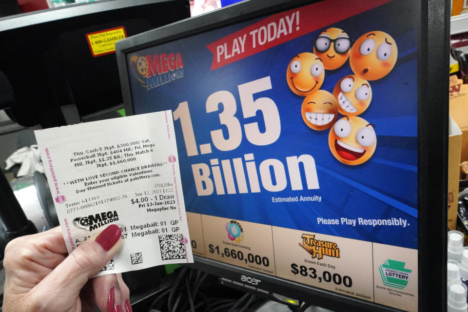 A customer at the Cranberry Super Mini Mart in Cranberry, Pa., shows her Mega Millions ticket on Thursday, Jan. 12, 2023. (AP Photo/Gene J. Puskar)