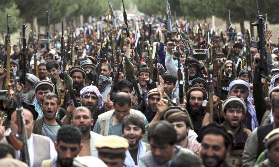 Afghan militiamen in Kabul join Afghan security forces during a gathering to mobilise local militias to try to stem Taliban military gains.