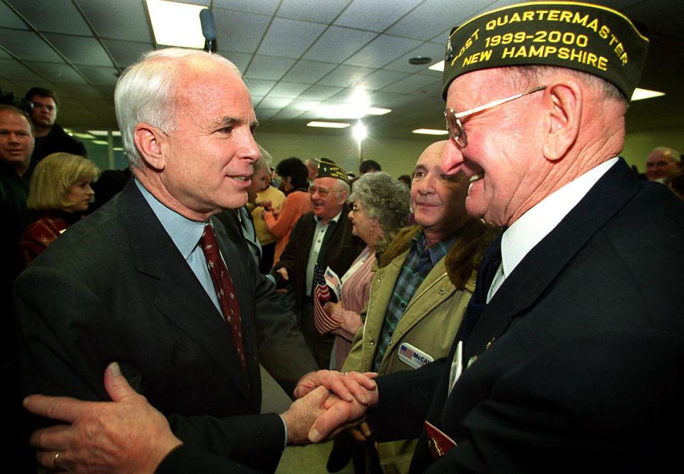 <p>McCain shakes hands with World War II veteran Paul Metcalf after a town hall meeting at Salem High School in Salem, Massachusetts on Jan. 23, 2000.</p>