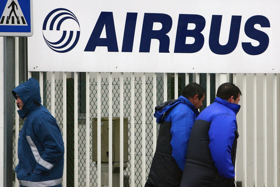 ** FILE ** Airbus employees of the Saint-Nazaire plant walk past the plant's entrance in Saint-Nazaire, western France, in this March 6, 2007 file photo. Airbus parent company EADS announced Wednesday Dec.19; 2007 it has chosen France's Latecoere, Germany's MT Aerospace and Britain's GKN as preferred bidders for six factories it is selling off in a major restructing. EADS, or European Aeronautic Defence & Space Co., and subsidiary Airbus are in talks on a full selloff of Britain's Filton plant, which makes wings and sub-assemblies, to GKN. The company is in talks on forming joint ventures with a substantial minority stake for EADS for the other five sites: Meault and Saint-Nazaire in France, and Nordenham, Varel and Augsburg in Germany. (AP Photo/David Vincent)