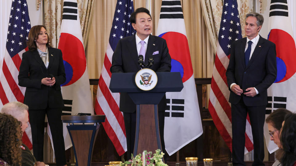 South Korean President Yoon Suk Yeol, flanked by Vice President Kamala Harris and Secretary of State Antony Blinken, speaks at the State Department.