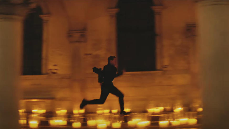 Tom Cruise runs through a candlelit church in Mission:Impossible - Dead Reckoning Part One.