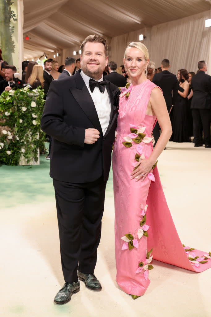 James in tuxedo and Julia in gown with floral accents