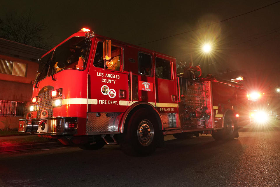 Los Angeles County Fire Department vehicles sit at a medical call Friday, Jan. 7, 2022, in Inglewood, Calif. Occasionally, firefighters transport patients to the hospital in fire engines because of short staffing amid an explosion in omicron-fueled coronavirus infections at an ambulance company that the fire department contracts with. (AP Photo/Mark J. Terrill)