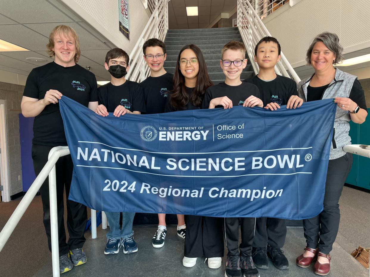 Members of Preston Middle School's National Science Bowl team that won the Colorado regional championship to advance to the national competition show off their championship banner at the school Wednesday. Pictured, from left to right, are coach Tyler Cloud, team members Samer Abdo, Eli Rauscher, Ella Wang, Evan Mainz, Alex Wang and school principal Amy Kirby.