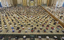 Indonesian Muslims pray spaced apart to help curb the spread of coronavirus outbreak during an Eid al-Fitr prayer marking the end of Ramadan at Al Akbar mosque in Surabaya, East Java, Indonesia, Thursday, May 13, 2021. Muslims celebrated the holiday in a subdued mood for a second year Thursday as the COVID-19 pandemic again forced mosque closings and family separations on the holiday marking the end of Islam's holiest month of Ramadan. (AP Photo/Trisnadi)