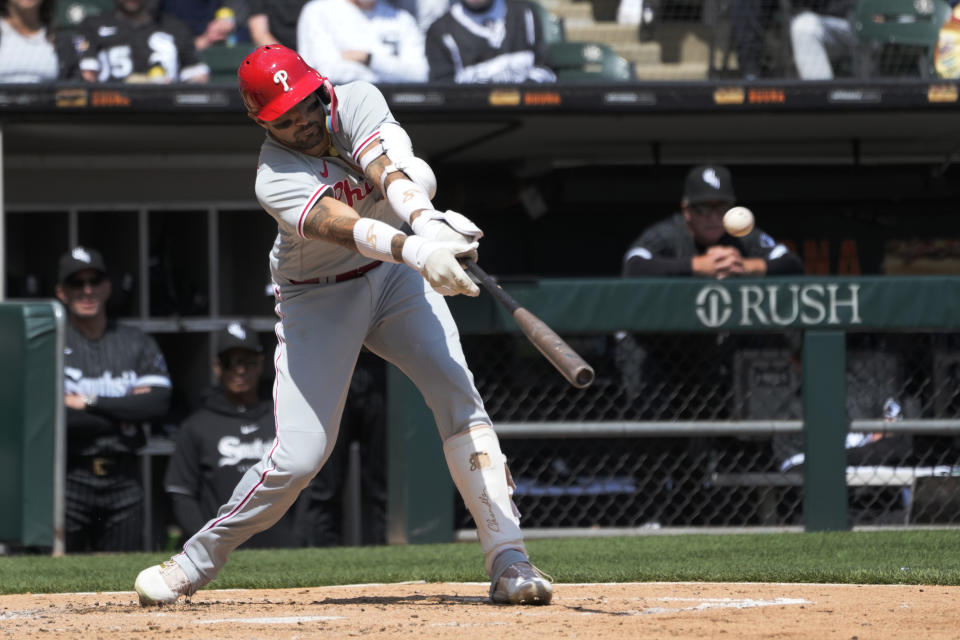 Philadelphia Phillies' Nick Castellanos slaps an RBI single off Chicago White Sox starting pitcher Mike Clevinger during the third inning of a baseball game Wednesday, April 19, 2023, in Chicago. (AP Photo/Charles Rex Arbogast)