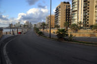 A street is empty of cars during a lockdown aimed at curbing the spread of the coronavirus, in Beirut, Lebanon, Friday, Jan. 15, 2021. Lebanon's parliament has approved a draft law to allow the importing of vaccines into the tiny country to fight the spread of coronavirus. (AP Photo/Bilal Hussein)