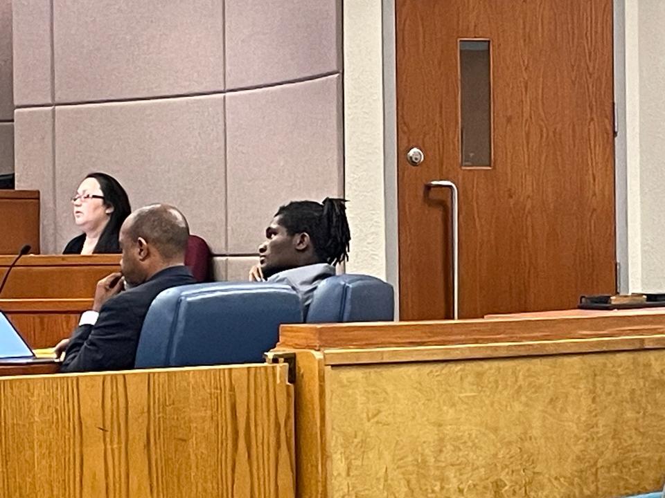 Brandon Jordan Merizier, right, sits beside his lawyer, James W. Smith, during trial.