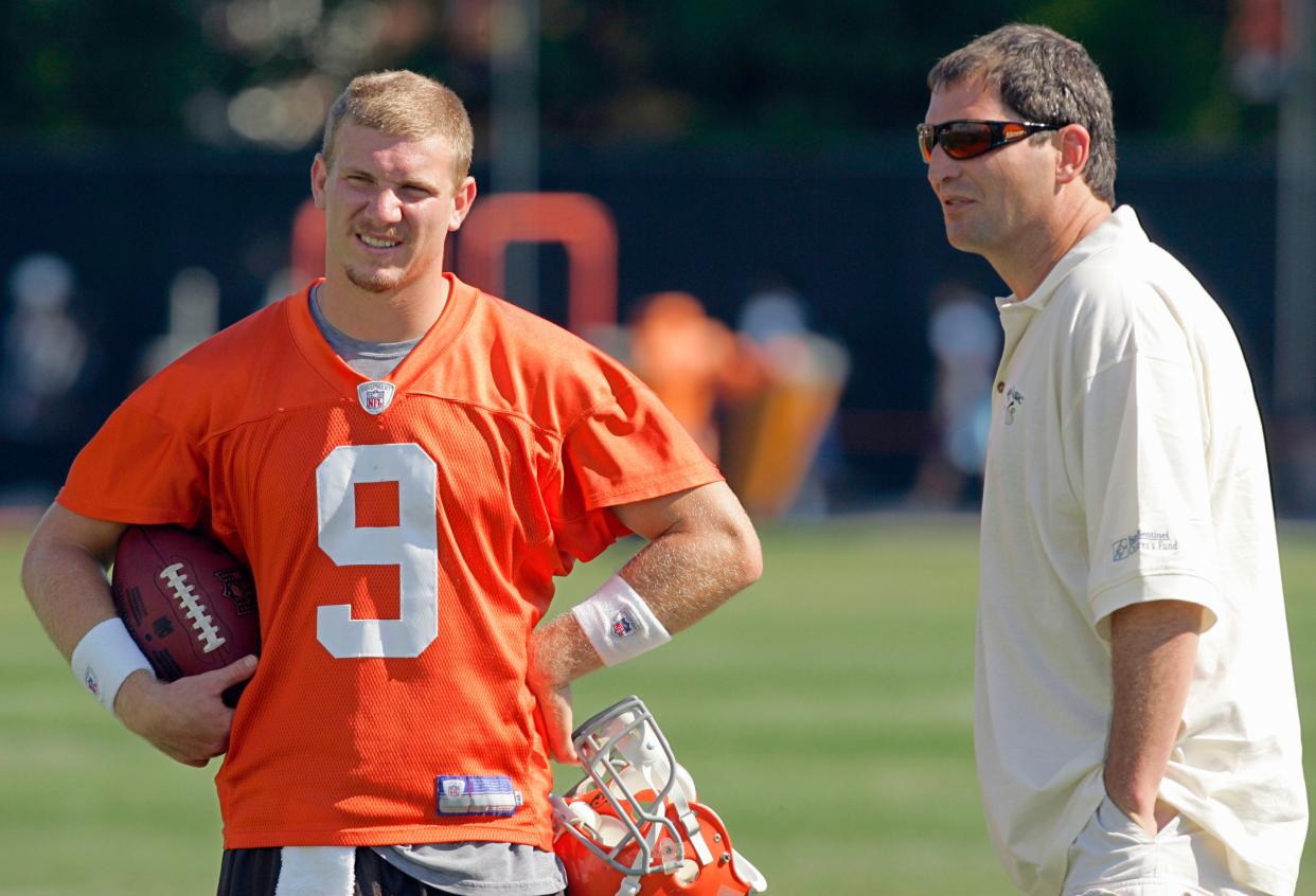 Former Cleveland Browns quarterback Bernie Kosar, right, talks with quarterback Charlie Frye (9) at the end of practice at the football team's training camp Wednesday, Aug. 16, 2006, in Berea, Ohio. (AP Photo/Mark Duncan)