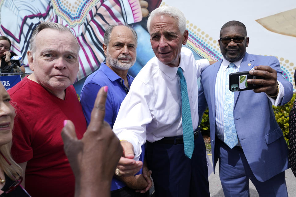 FILE - Rep. Charlie Crist, D-Fla., second from right, talks with a supporter outside of the United Teachers of Dade offices, May 31, 2022, in Miami Springs, Fla. Crist was endorsed by the Florida Education Association (FEA) and teachers unions from across Florida in his campaign for governor of Florida. (AP Photo/Lynne Sladky, File)