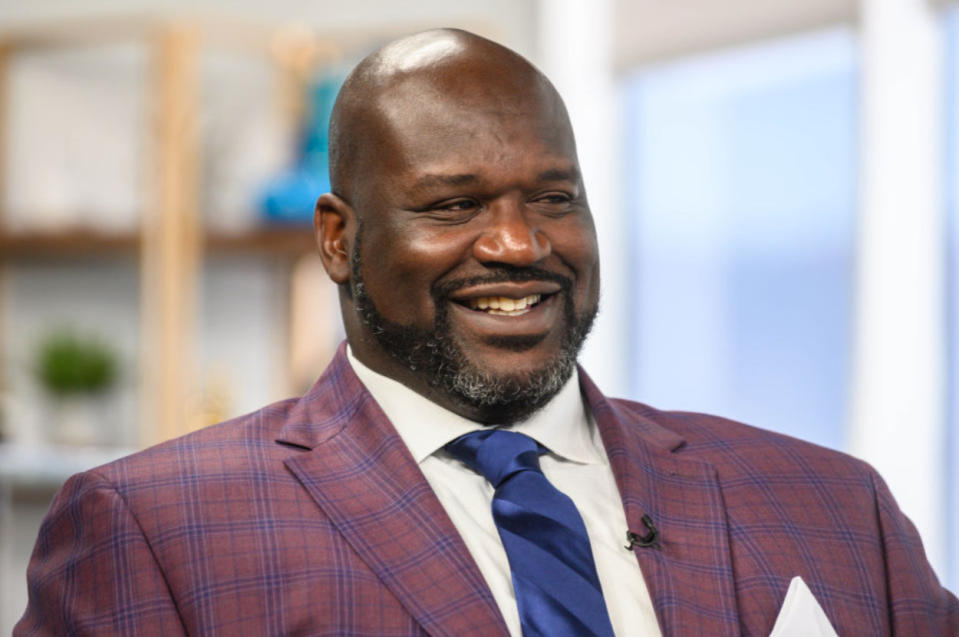 Shaquille O'Neal smiling in a suit